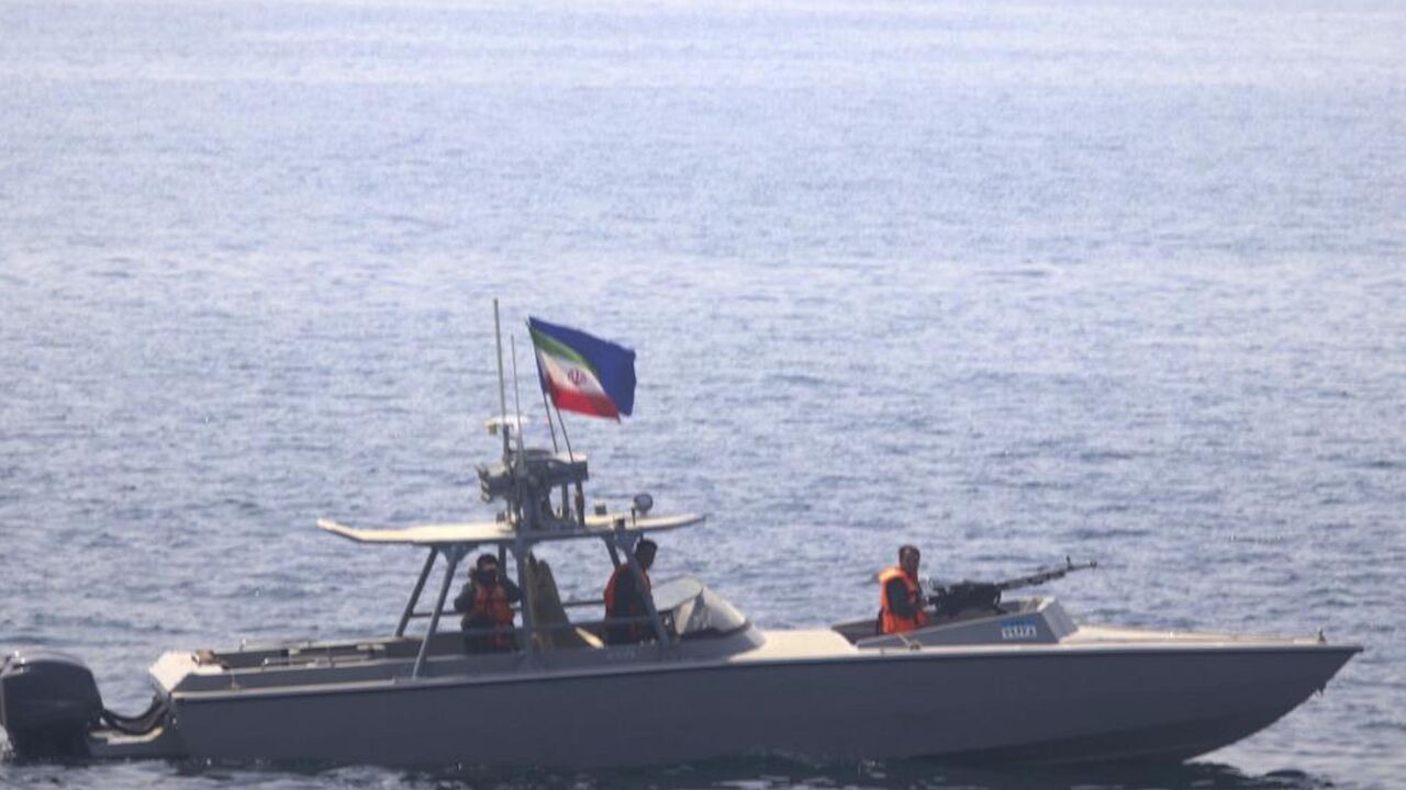 In this photo made available by the US Navy, a boat of Iran's Islamic Revolutionary Guard Corps Navy operates in close proximity to patrol coastal ship USS Sirocco.