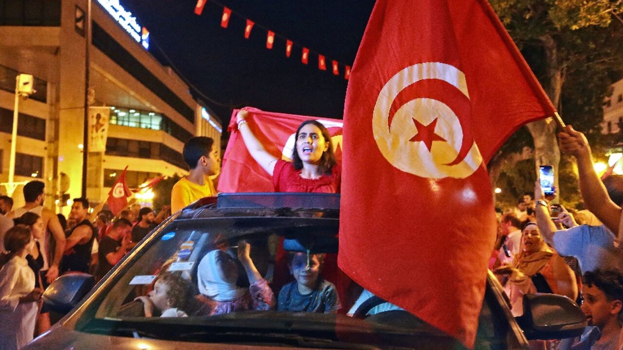Supporters of Tunisia's President Kais Saied rejoice on Habib Bourguiba Avenue in the capital Tunis after the projected outcome of a constitutional referendum was announced