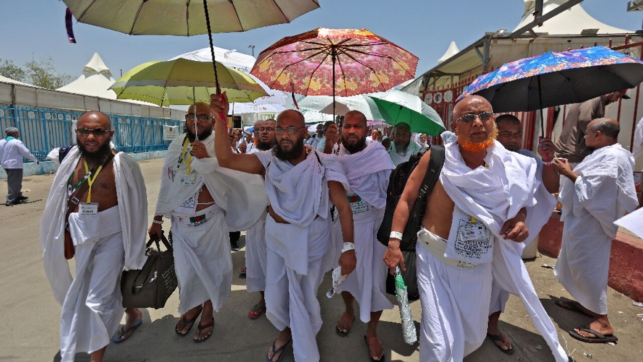 Muslim pilgrims arrive under a burning sun at the encampment in Mina 