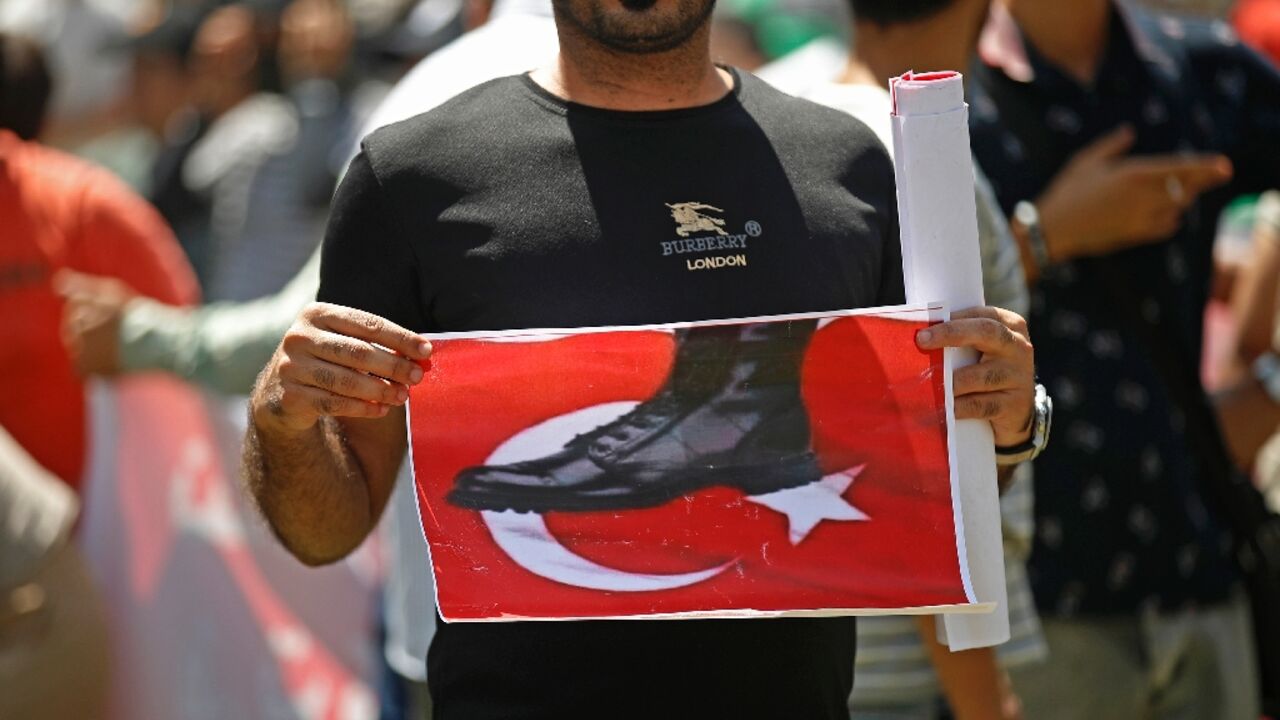 An Iraqi takes part in a demonstration in Baghdad against an attack on the country's autonomous Kurdistan region blamed on Turkey