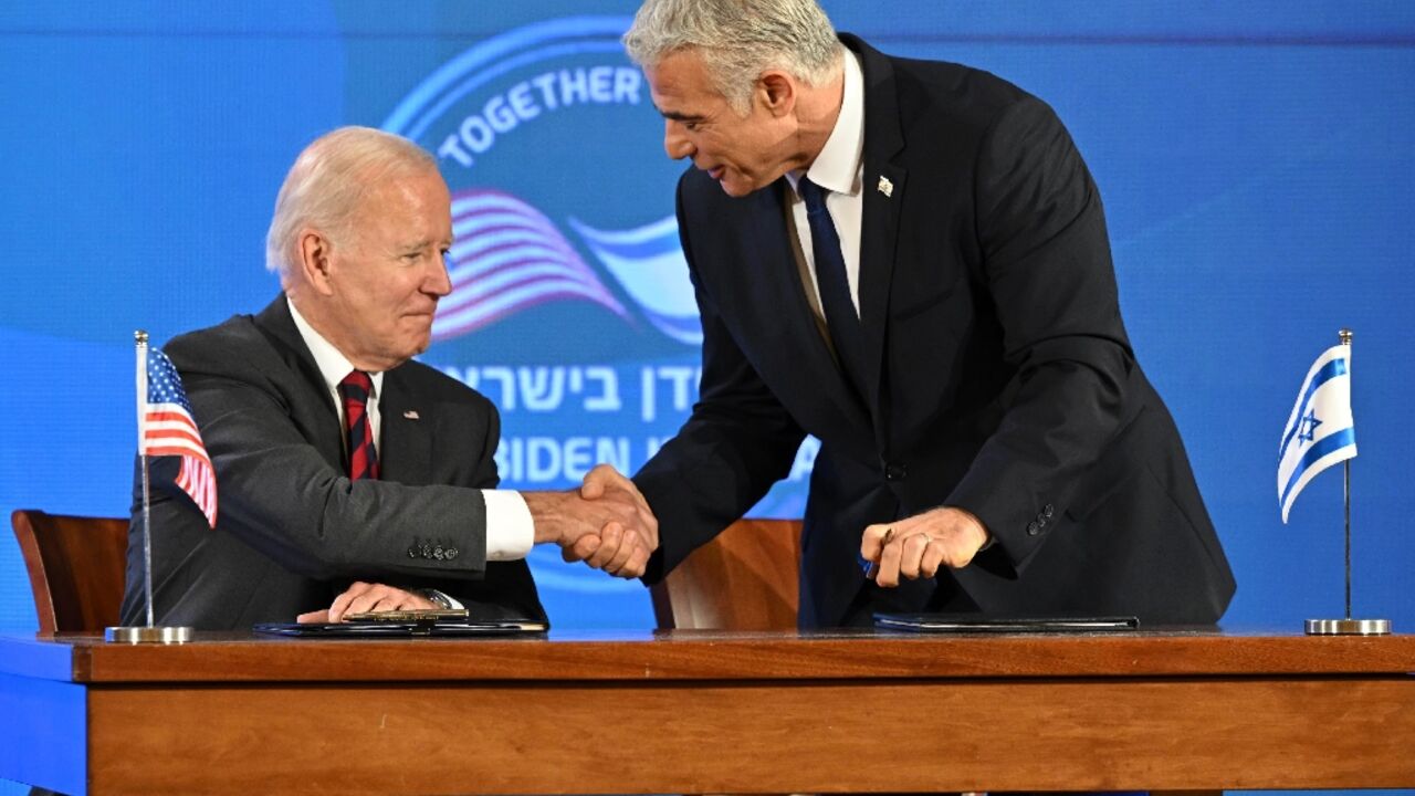US President Joe Biden and Israel's caretaker Prime Minister Yair Lapid shake hands before signing a security pledge in Jerusalem