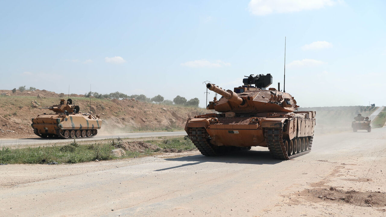 Turkish military tanks drive past the town of Ariha on the M4 highway in Syria's rebel-held northwestern Idlib province on May 7, 2020. 