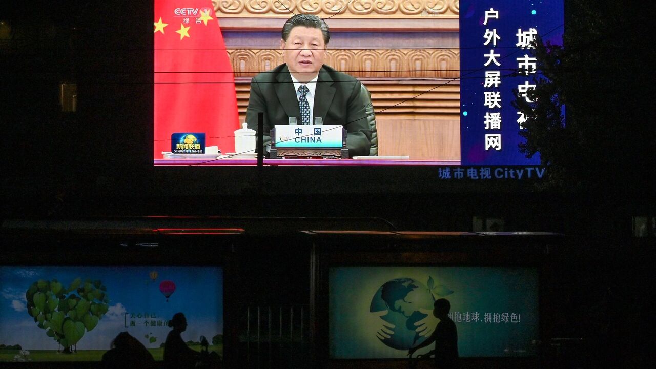 A large screen shows a news program featuring Chinese President Xi Jinping speaking at the opening of the virtual BRICS Summit.