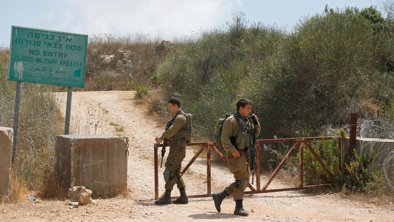 Israeli soldiers close a gate near the Kibbutz of Shtula, near the border with Lebanon, July 3, 2022.