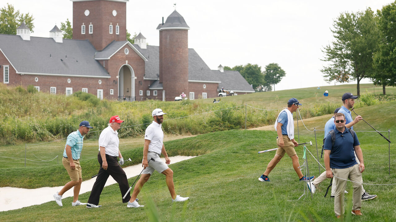 Former US President Donald Trump talks to Bryson DeChambeau of Crushers GC and Dustin Johnson of 4 Aces GC walk from the 14th green to the 15th tee during the pro-am prior to the LIV Golf Invitational at the Trump National Golf Club, Bedminster, New Jersey, July 28, 2022.