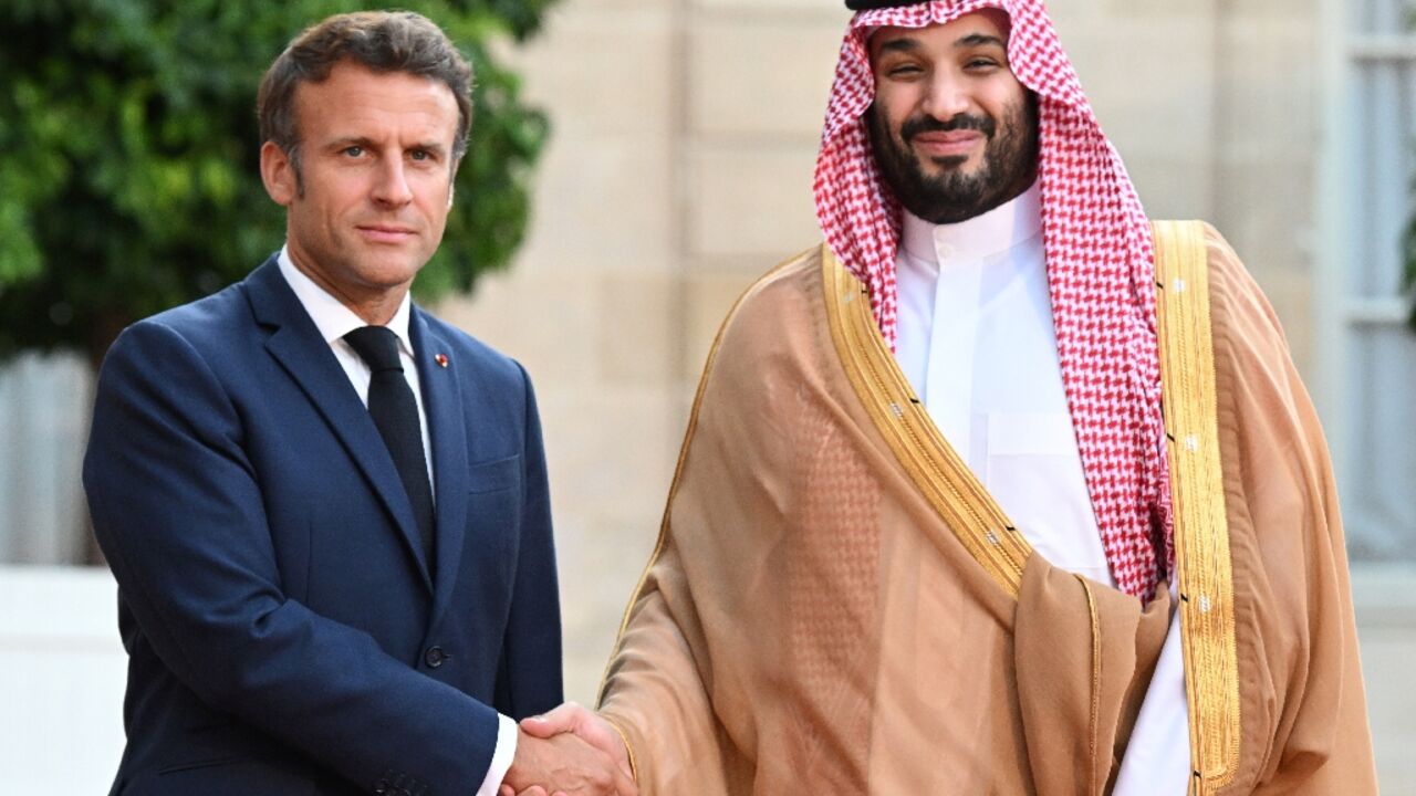 Macron warmly greeted the kingdom's de-facto ruler ahead of a dinner, defying objections from activists