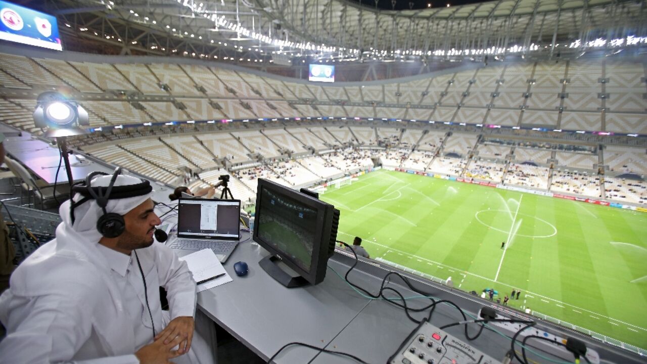 A commentator prepares for the Qatar Stars League match between Al-Arabi and Al-Rayyan at the Lusail stadium, the venue for the World Cup final