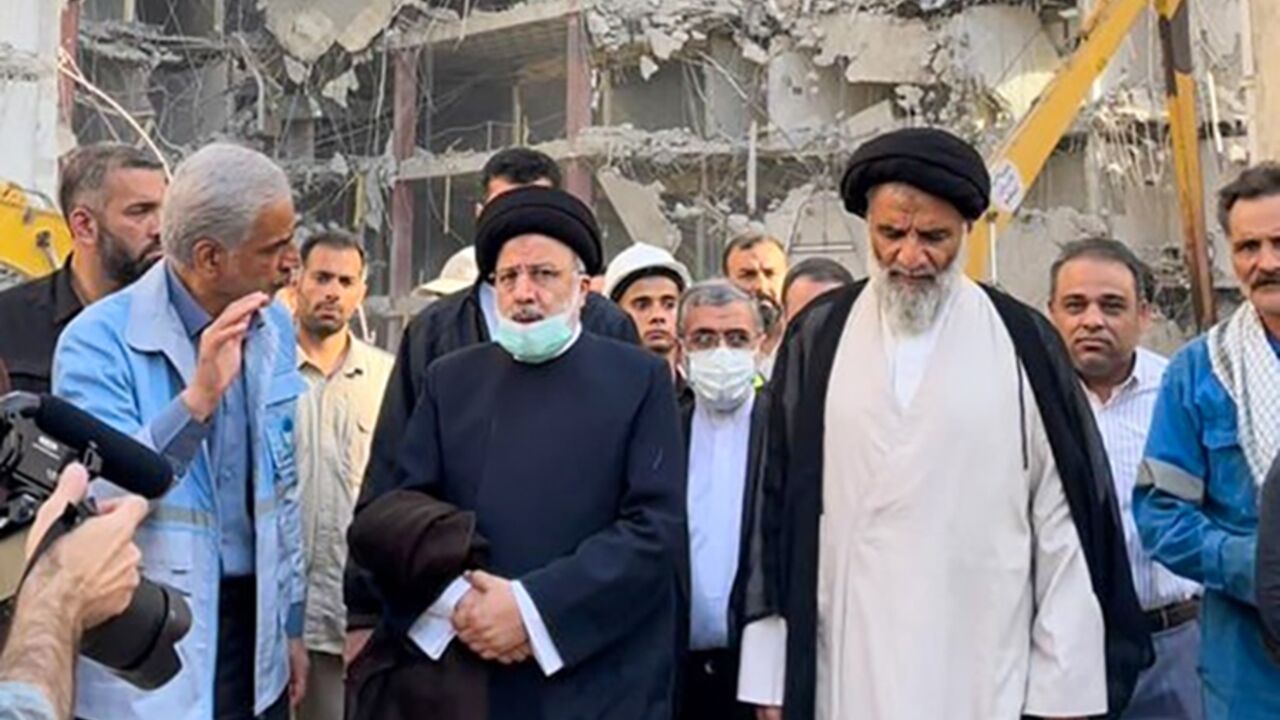 A handout picture provided by the Iranian presidency shows President Ebrahim Raisi visiting the site of the Abadan building collapse on June 3, 2022