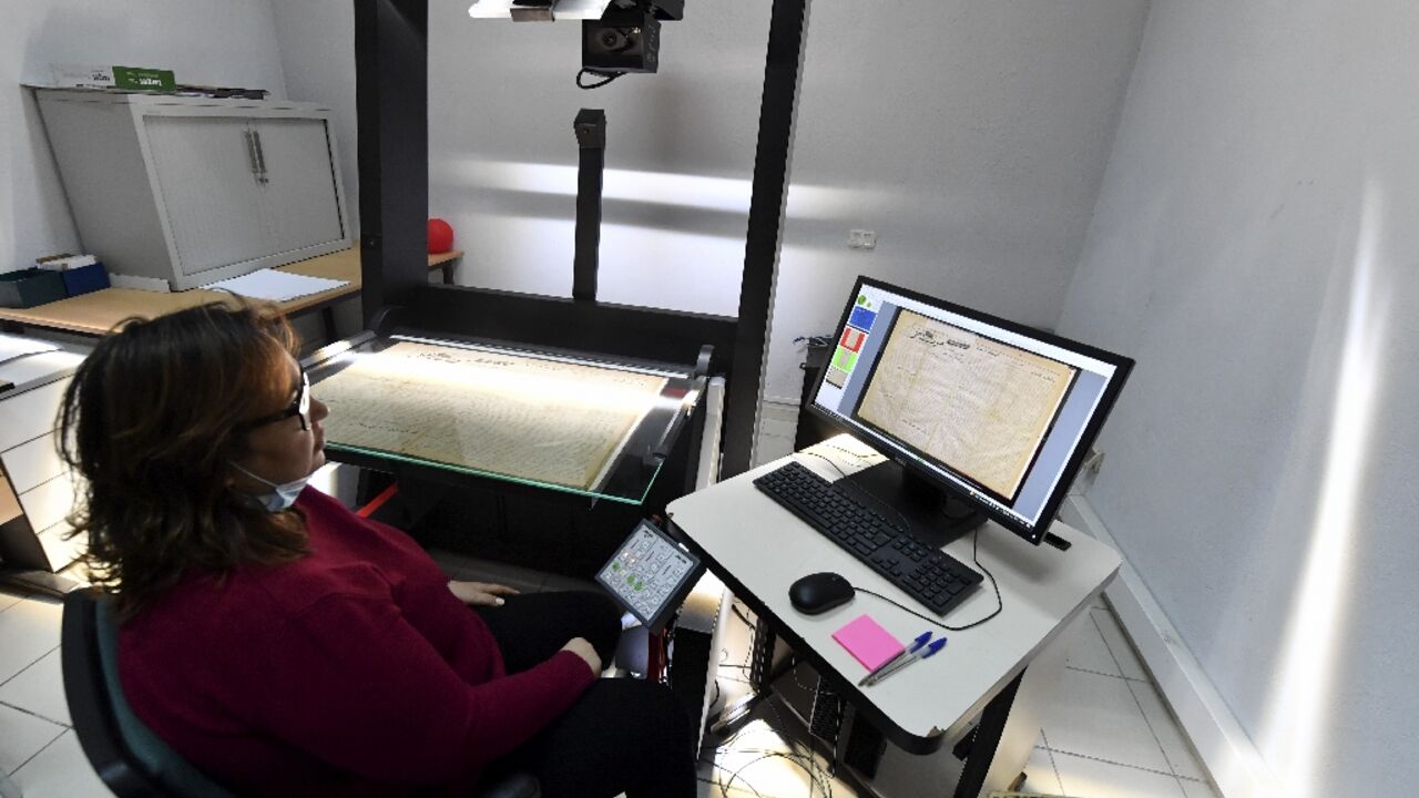An employee at the National Library of Tunisia consults scanned documents 