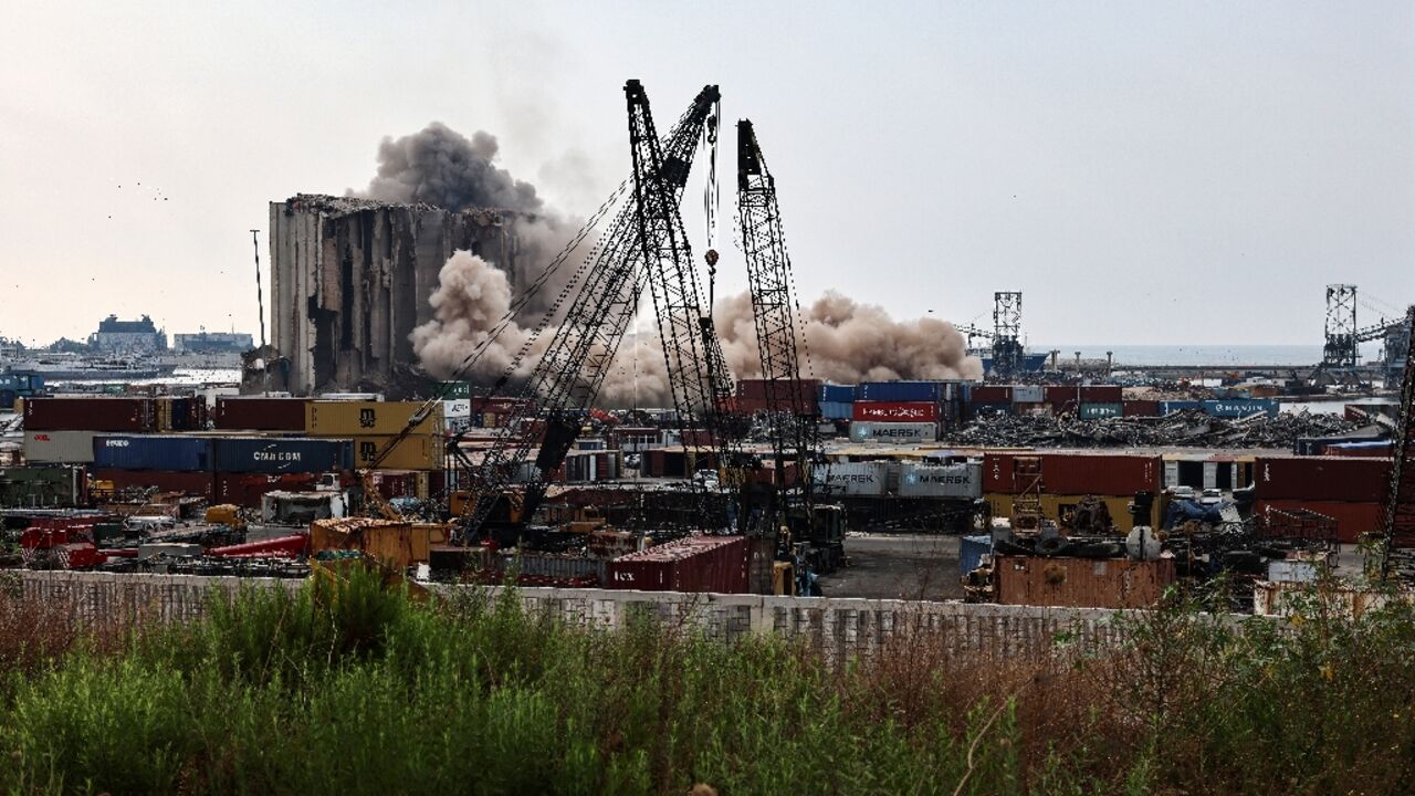 Heavy dust rises as a part of the grain silos in the port of Beirut collapse on August 4, 2022, two years since a giant explosion ripped through the capital