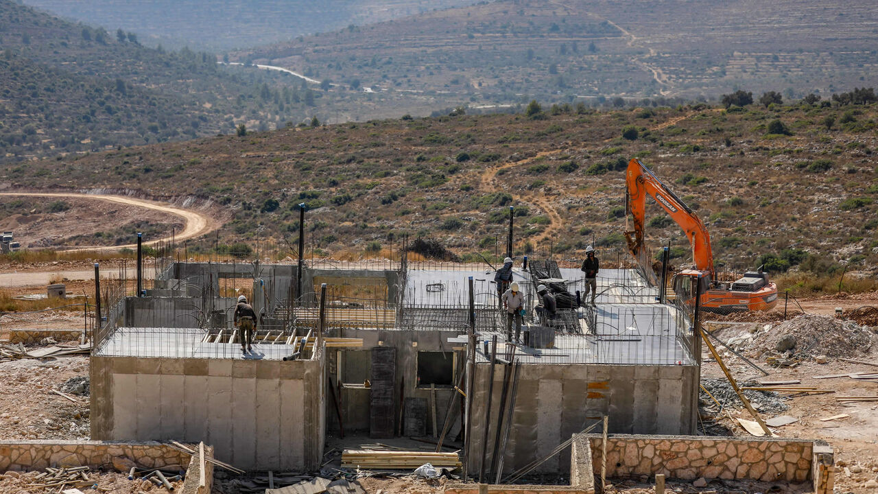 Palestinian laborers work at a construction site in the Israeli settlement of Kerem Reim, West Bank, July 31, 2019.