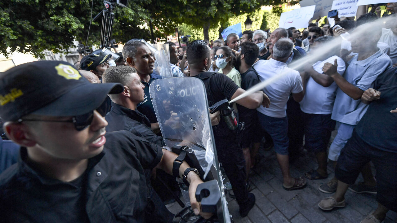 A policeman sprays tear gas at protesters during a demonstration along Habib Bourguiba Avenue, against their president and the upcoming July 25 constitutional referendum, Tunis, Tunisia, July 22, 2022.