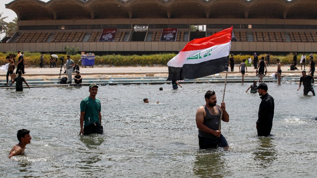 Supporters of Iraqi cleric Moqtada Sadr cool off in Baghdad's Green Zone, where they continue to protest a rival Shiite faction's nomination for prime minister