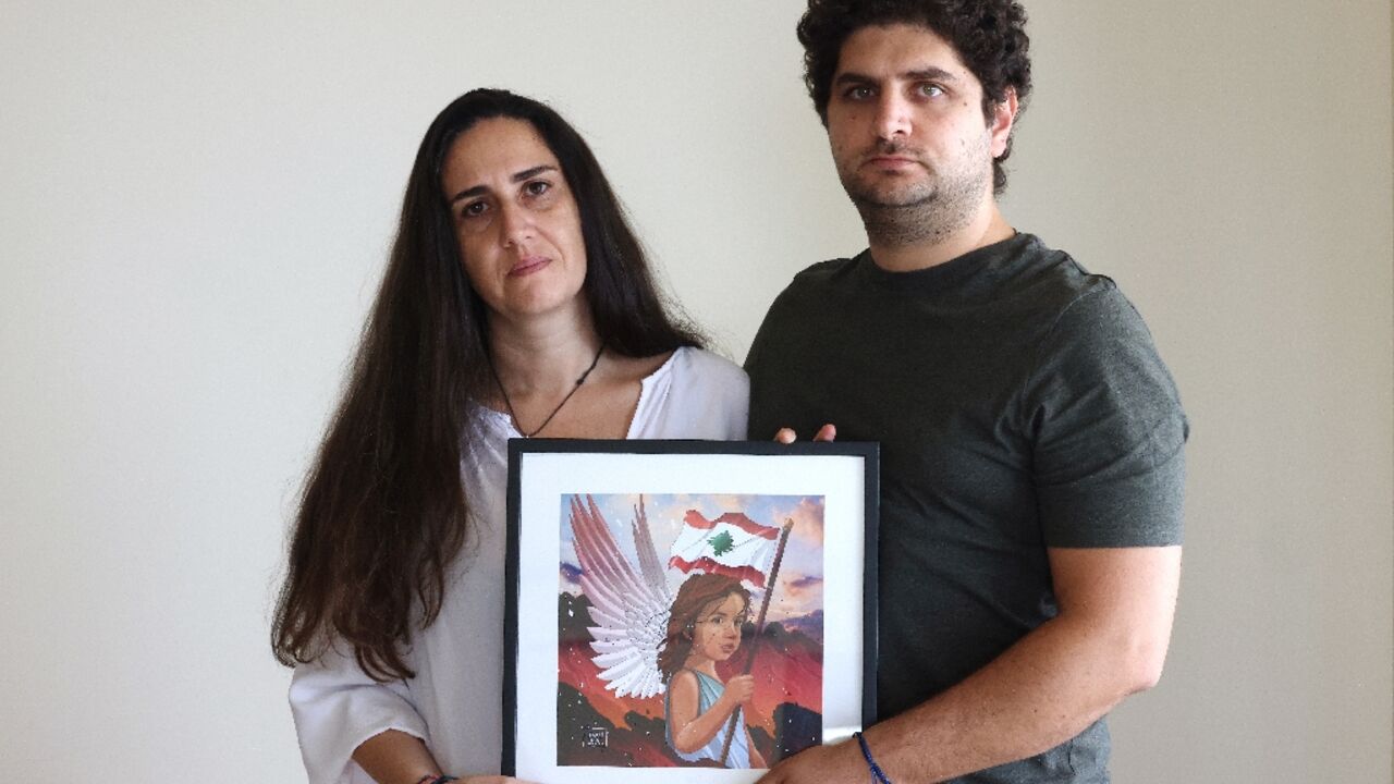 Paul and Tracy Naggear hold a framed drawing for their late daughter Alexandra, who was killed in the Beirut port blast of August 2020