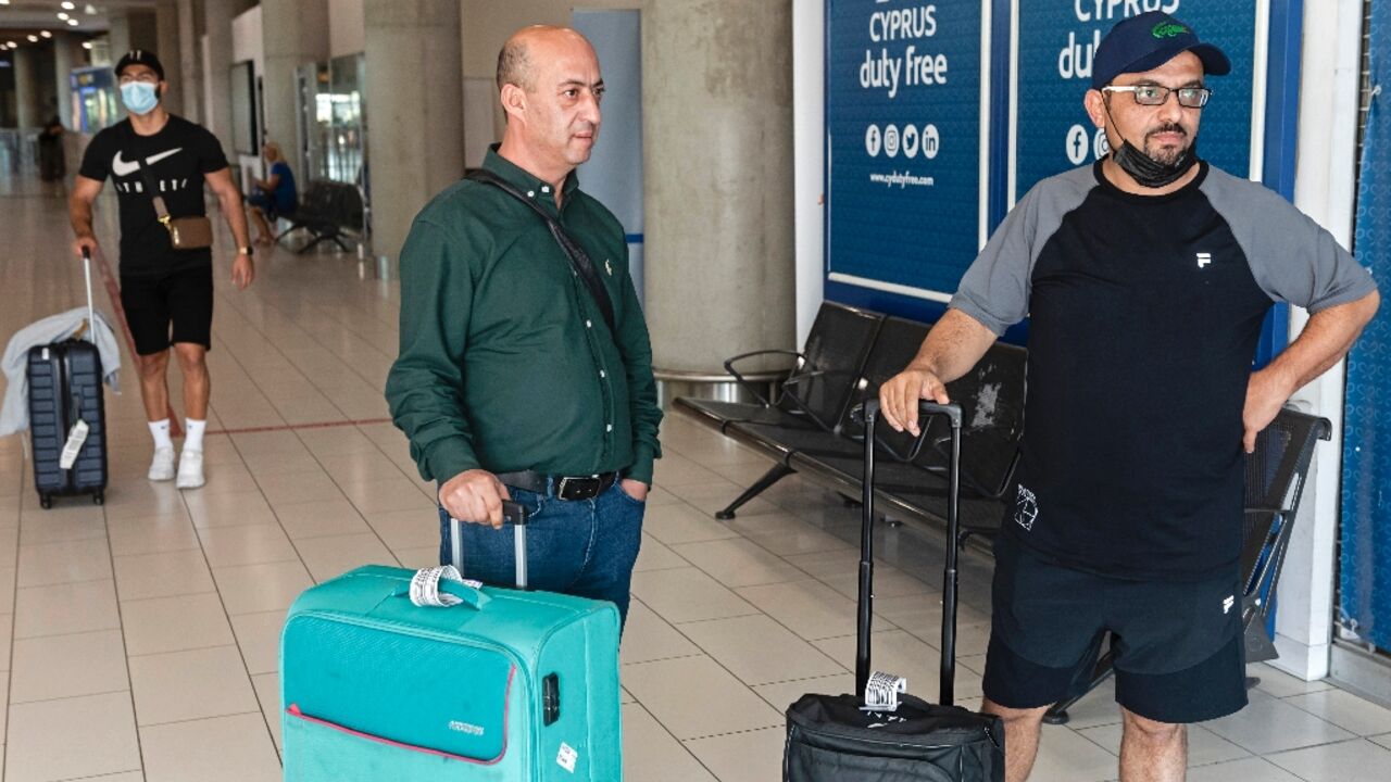 Palestinians leave Larnaca International Airport in Cyprus after arriving aboard the first flight open to Palestinians from Israel's Ramon airport