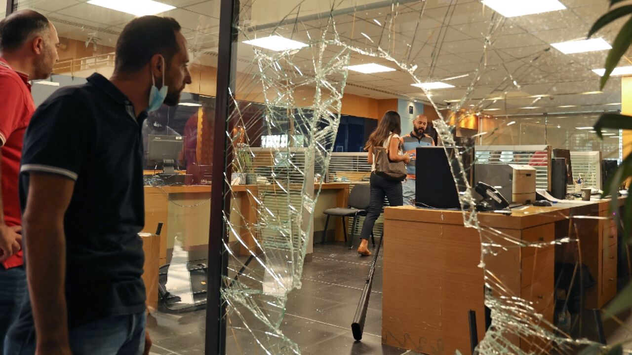 The glass facade of a bank in the Lebanese capital Beirut is seen after a woman stormed it demanding access to her sister's deposits to allegedly pay for her hospital fees