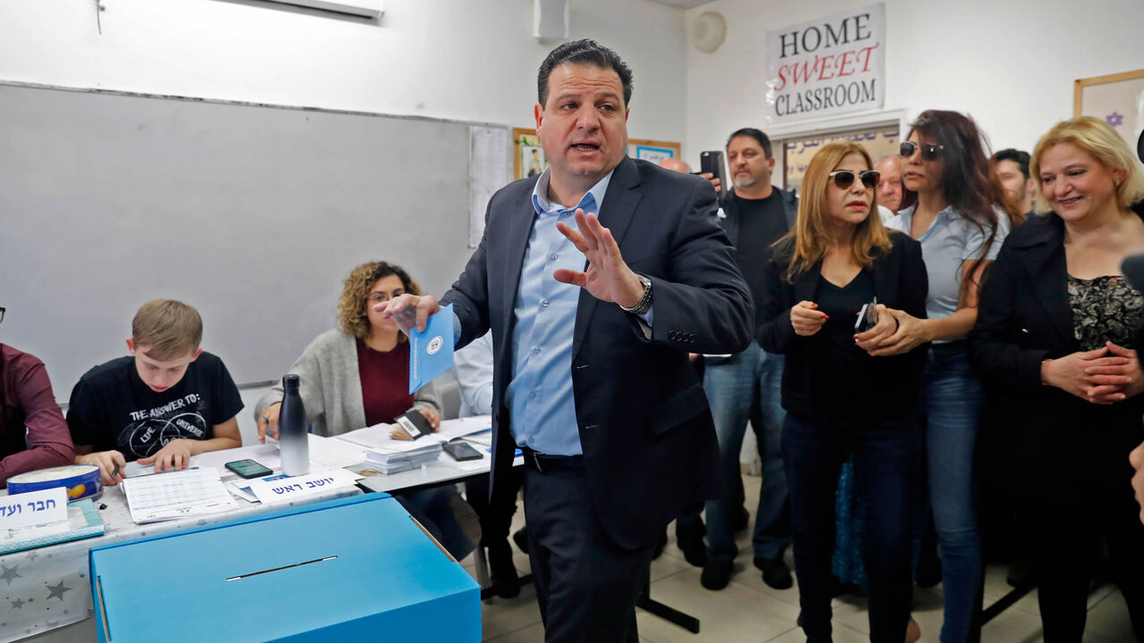Israel's head of the mainly Arab Joint List Ayman Odeh casts his ballot accompanied by his family during the parliamentary election at a polling station, Haifa, Israel, March 2, 2020.