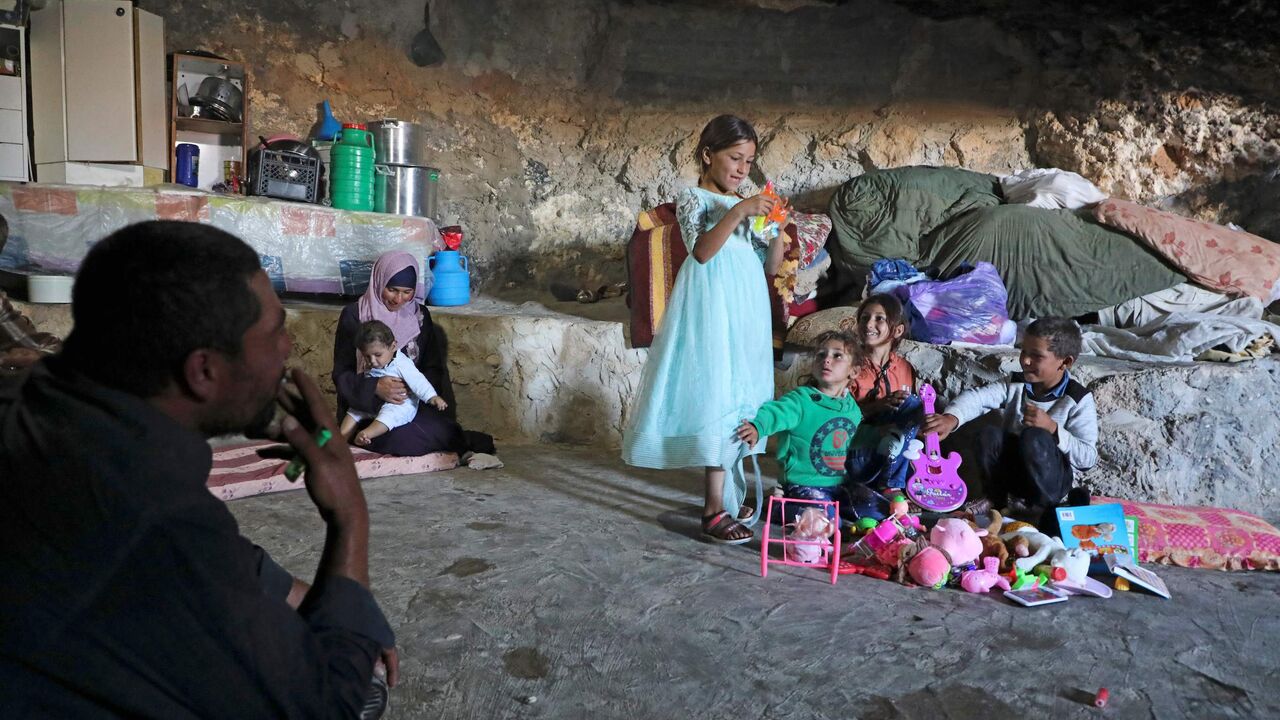 A Palestinian family whose house is located in Area C of the Israeli-occupied West Bank and was demolished by the military sit inside a cave.