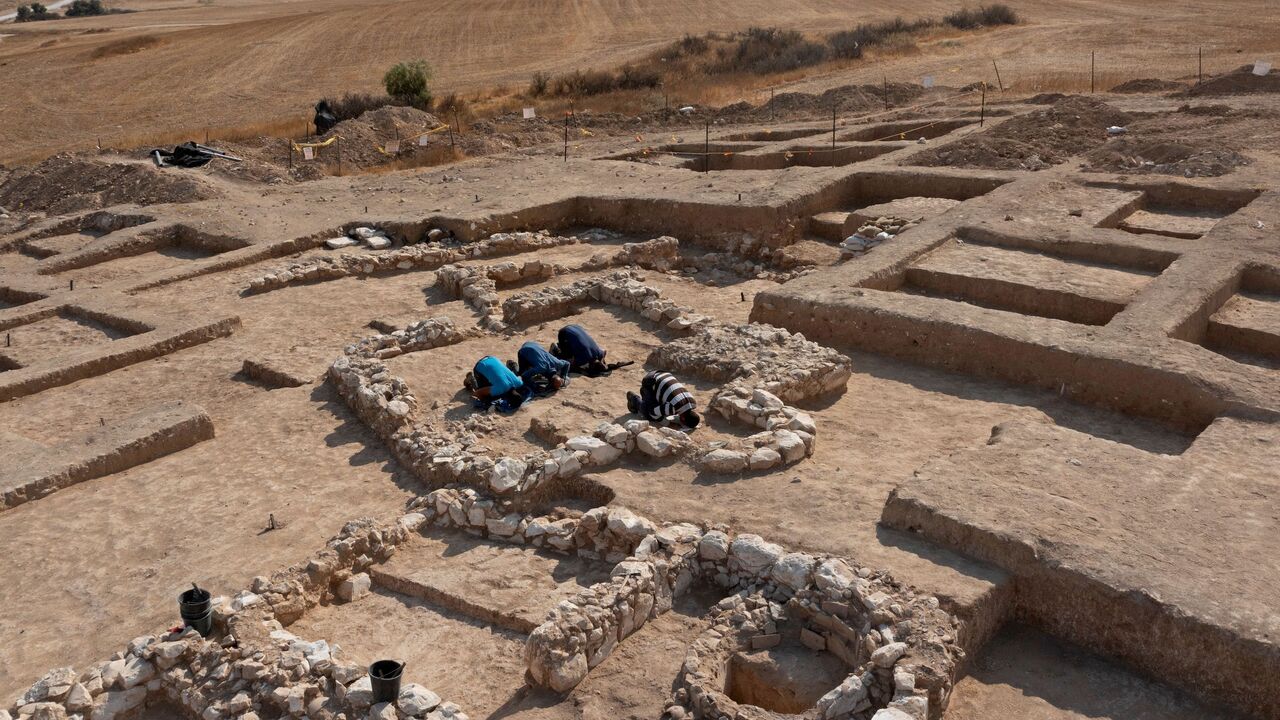 Muslim Palestinian workers of Israel's Antiquities Authority pray amid the remains of a recently discovered ancient mosque.