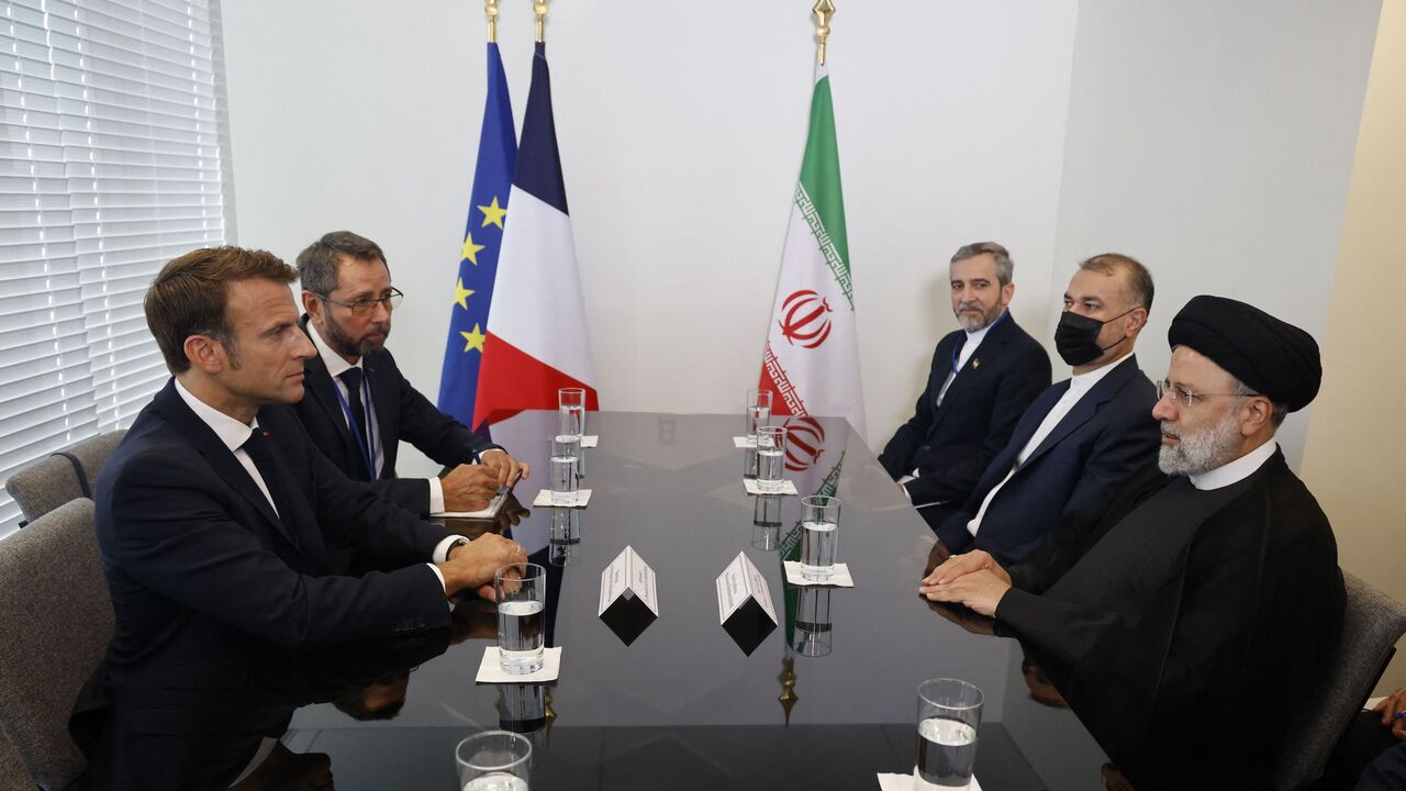French President Emmanuel Macron (L) holds a bilateral meeting with Iranian President Ebrahim Raisi.
