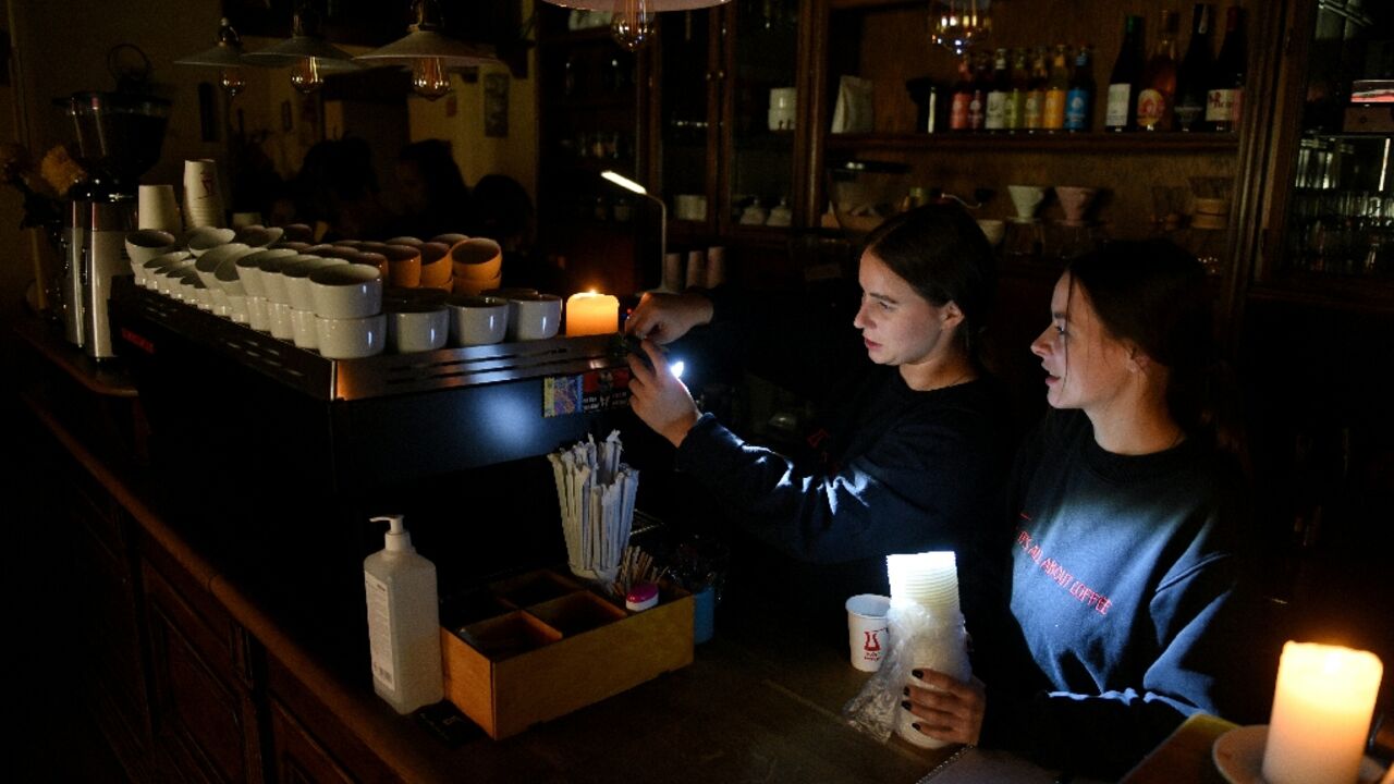 Employees prepare coffee in a cafe without electricity in western Ukrainian city of Lviv,  after Russian missiles targeted energy infrastructure