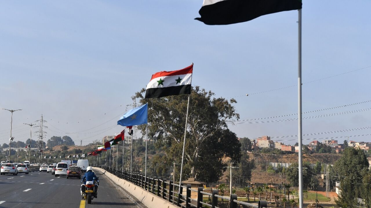 National flags of Arab countries line a highway in the Algerian capital Algiers