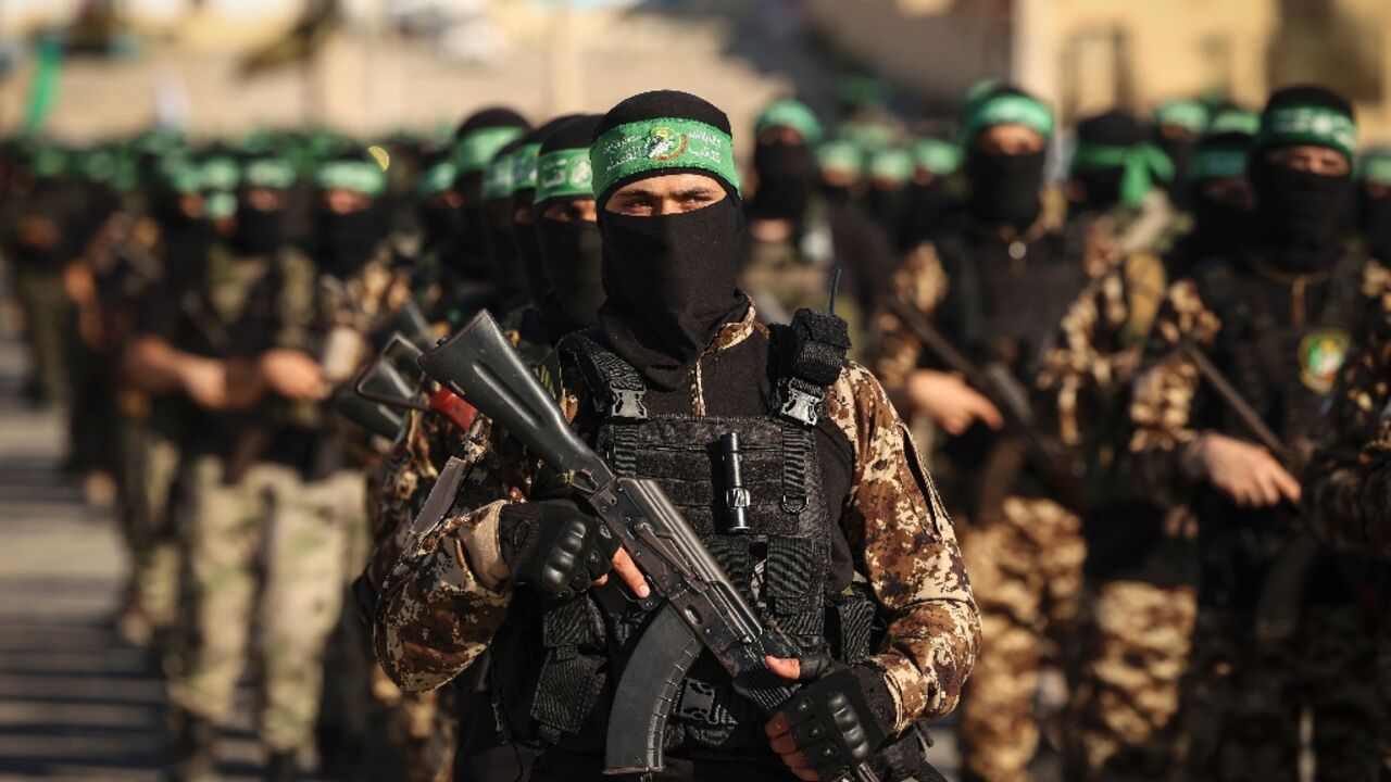 Masked members of the al-Qassam Brigades, the military wing of Hamas, march during a rally in Gaza City on July 20, 2022