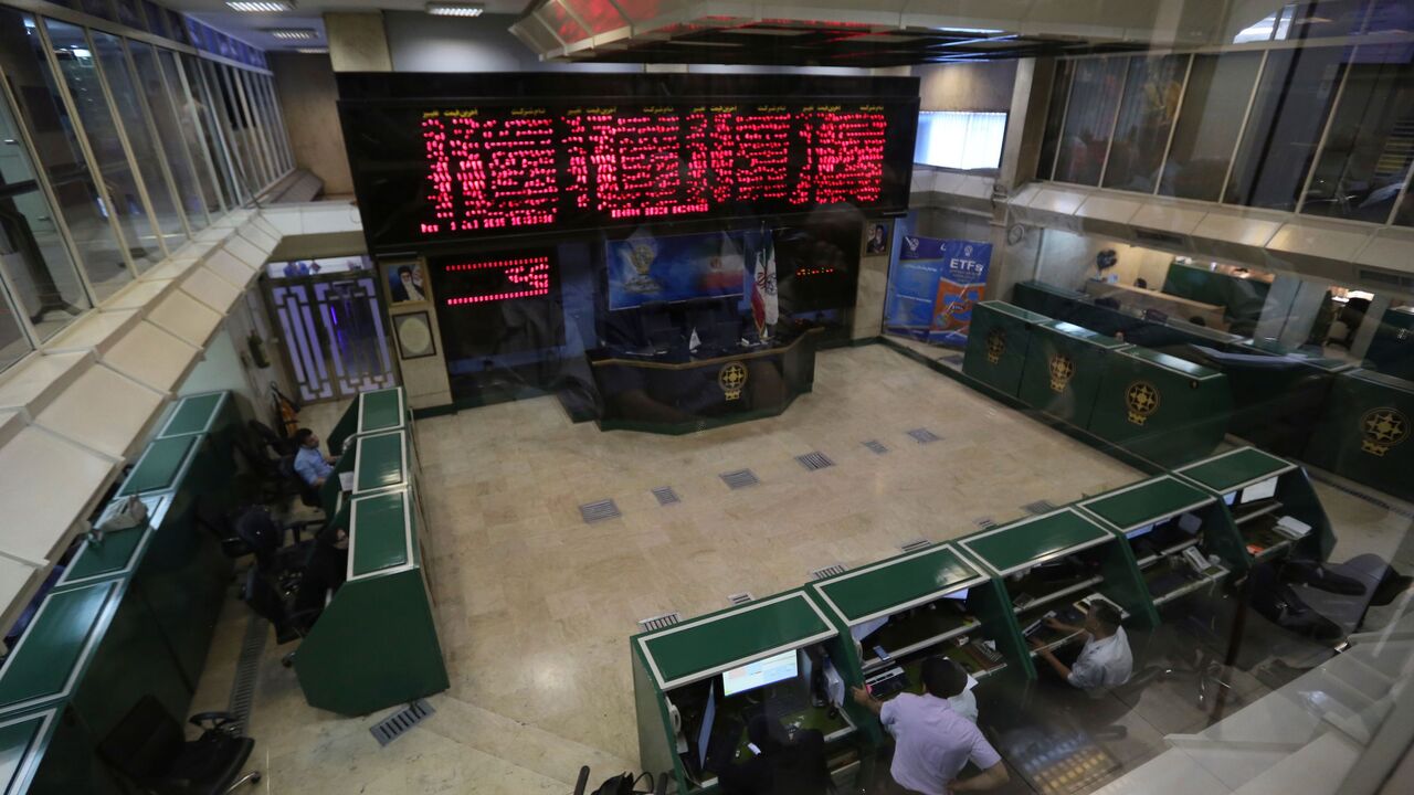 Iranian men monitor the stock market at Tehran Stock Exchange on July 1, 2019. (Photo by ATTA KENARE / AFP) (Photo credit should read ATTA KENARE/AFP via Getty Images)