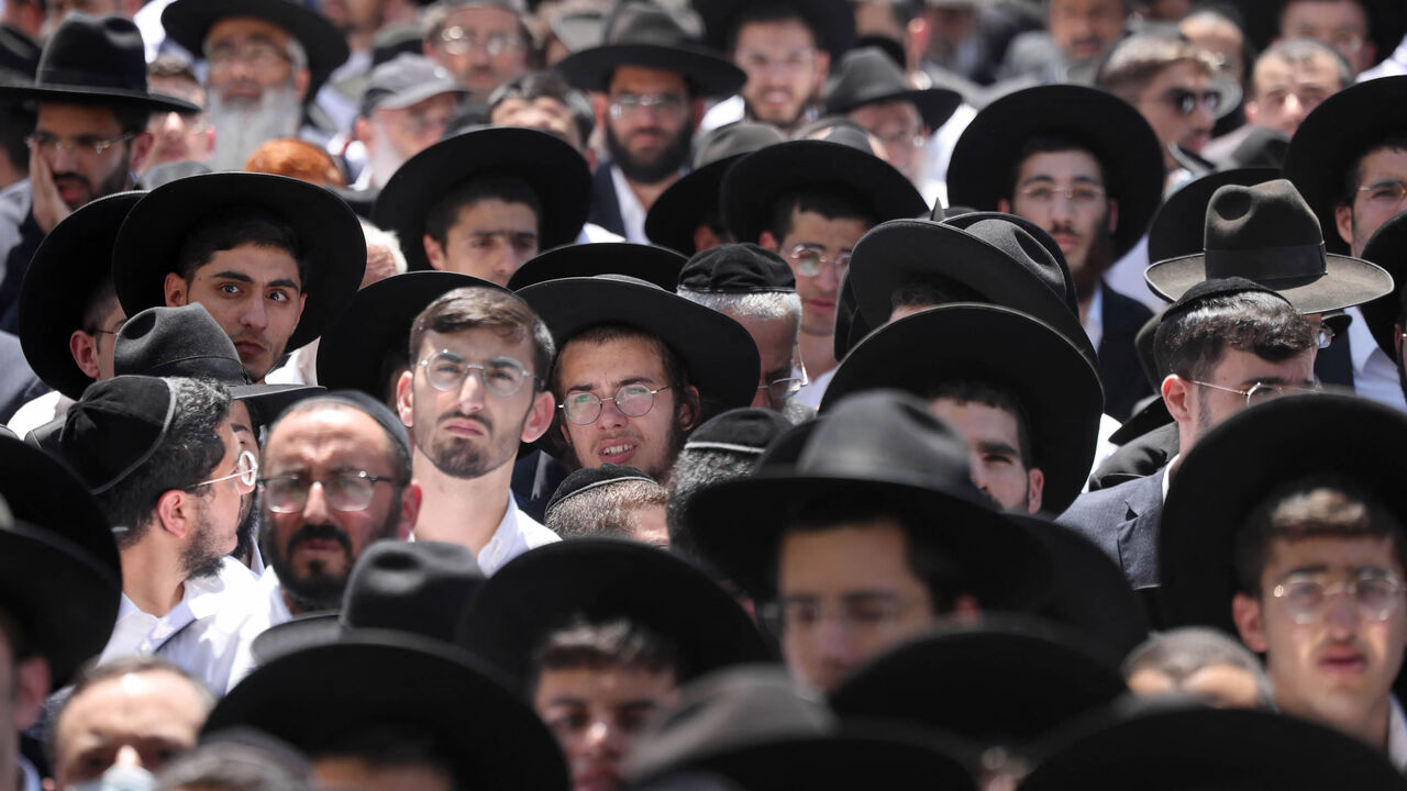 Thousands of ultra-Orthodox Jews attend the funeral of Rabbi Shalom Cohen, influential spiritual leader of Israel's largest ultra-Orthodox Shas party, Jerusalem, Aug. 22, 2022.