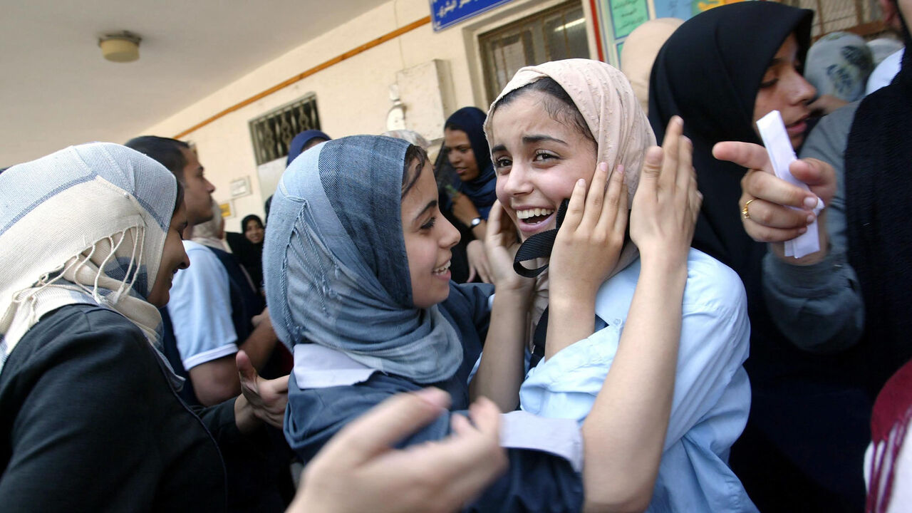 Palestinian students congratulate each other after receiving their test results of those accepted into the Bashir El Rayes women's secondary school, Gaza City, Gaza Strip, July 19, 2003.
