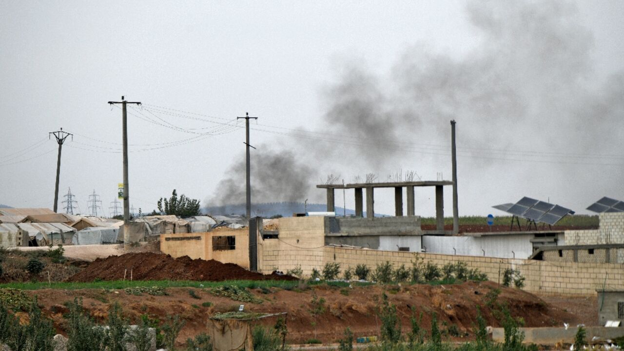 Smoke billows amid clashes between the Hayat Tahrir al-Sham (HTS) jihadist group and the Turkey-backed Syrian National Army (SNA) near the village of Jindires in Syria's rebel-held northern Aleppo province