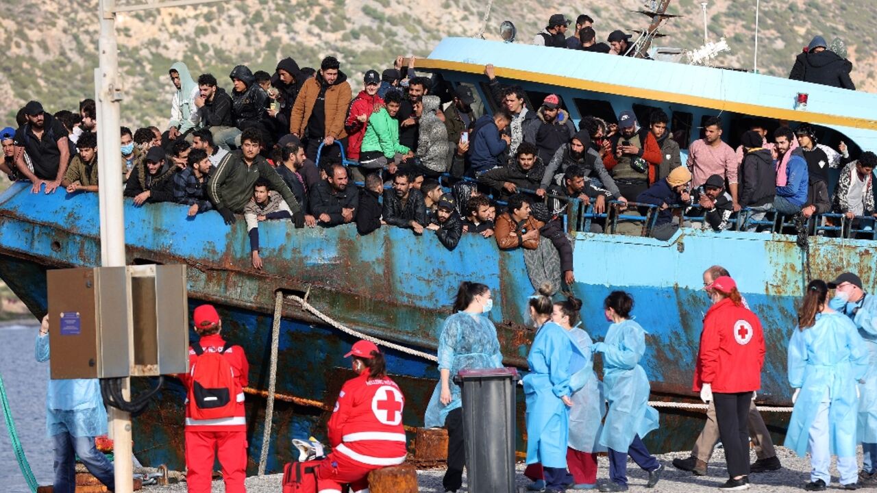 Hellenic Red Cross rescuers and health workers readied to help passengers disembark