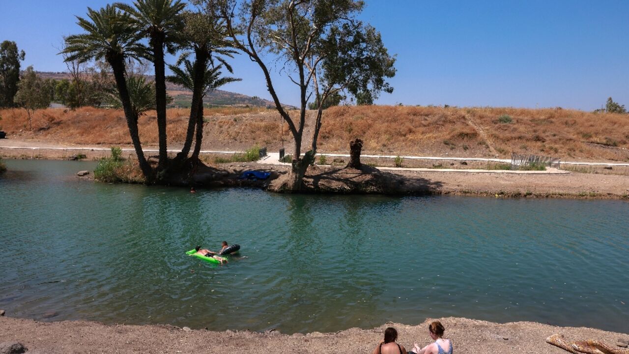 Israelis camping by the Jordan River near the Sea of Galilee, or Lake Tiberias, one of the main water sources in Israel, in this picture from July 13, 2021