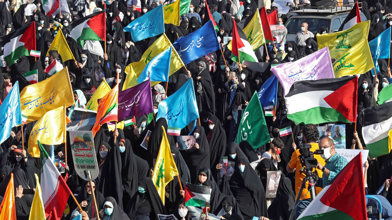 Iranian women wave Palestinian and national flags during a march to condemn the ongoing Israeli airstrikes on the Gaza Strip, Palestine Square, Tehran, Iran, May 19, 2021.