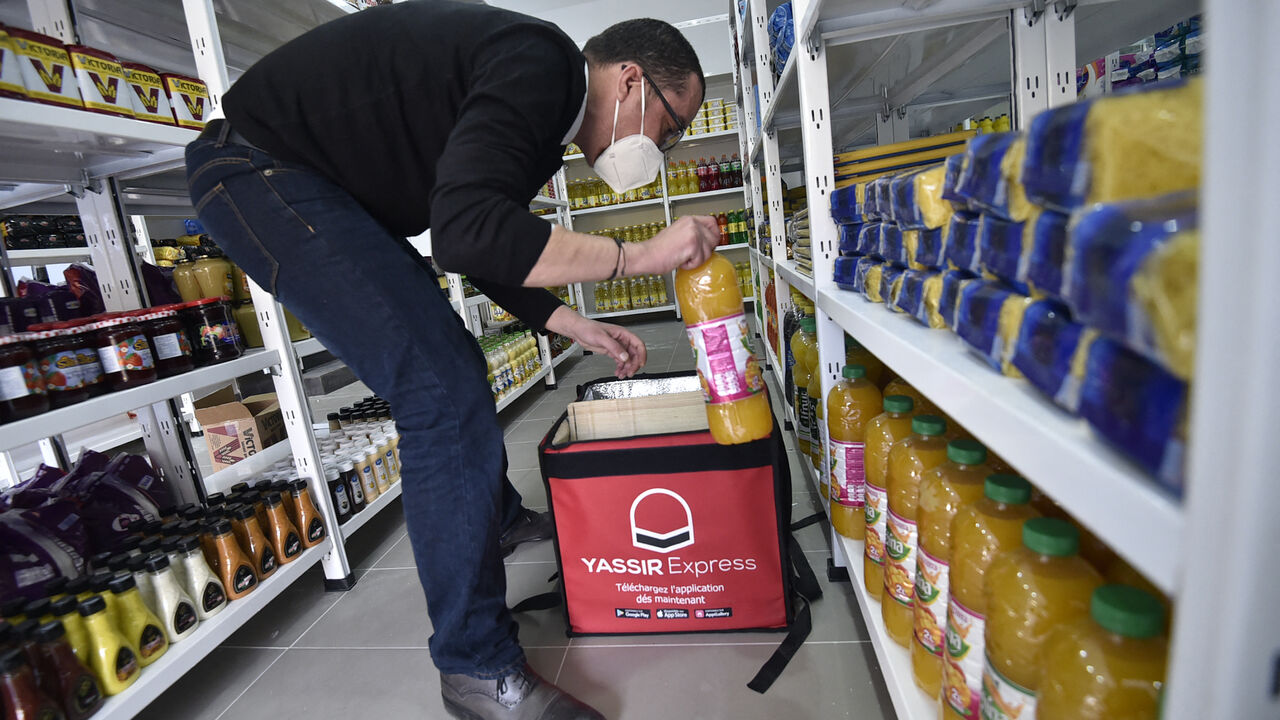 An employee prepares a basket of groceries at the storage department of the Algerian delivery company Yassir, in the capital Algiers on Feb. 23, 2022.