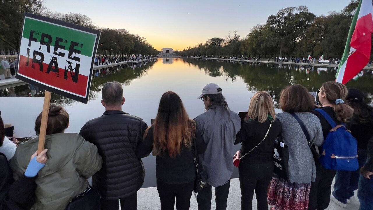 Demonstrators marching in solidarity with protesters in Iran stand around the Lincol Memorial Reflecting Pool in Washington, DC, on Oct. 29, 2022.  