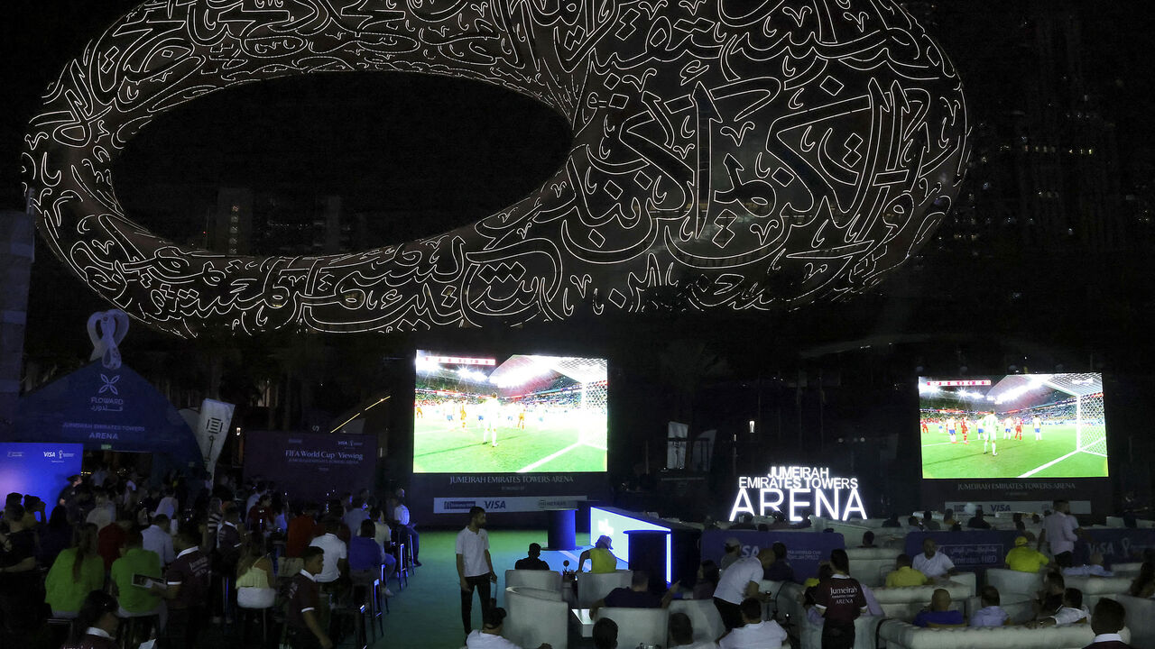 Soccer fans watch a live broadcast of the Qatar 2022 World Cup soccer match between Brazil and Switzerland, near the museum of the Future in Dubai, United Arab Emirates, Nov. 28, 2022.