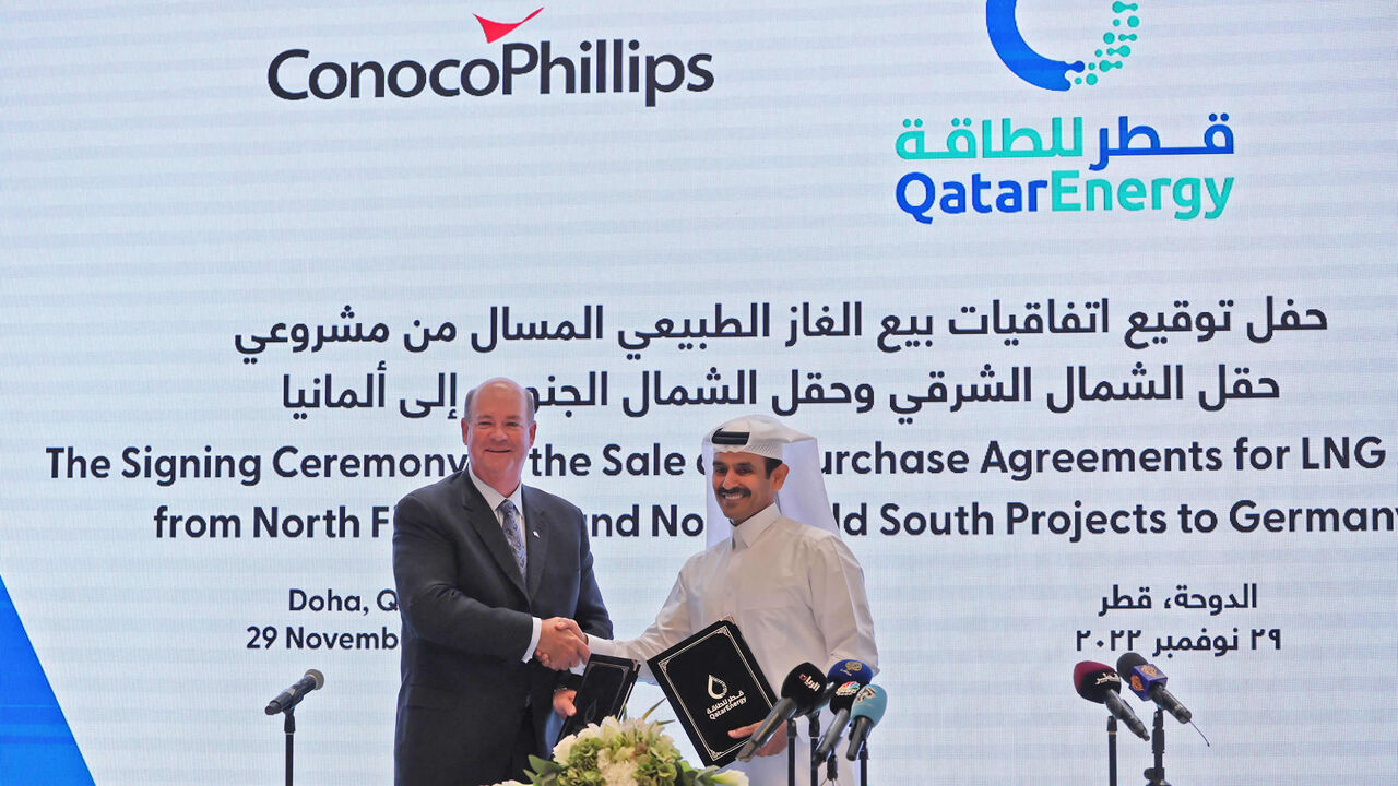 Saad Sherida al-Kaabi (R), Qatar's energy minister and CEO of QatarEnergy, and Ryan Lance (L), CEO of multinational corporation ConocoPhillips, exchange documents during a press conference announcing a new deal, Doha, Qatar, Nov. 29, 2022.