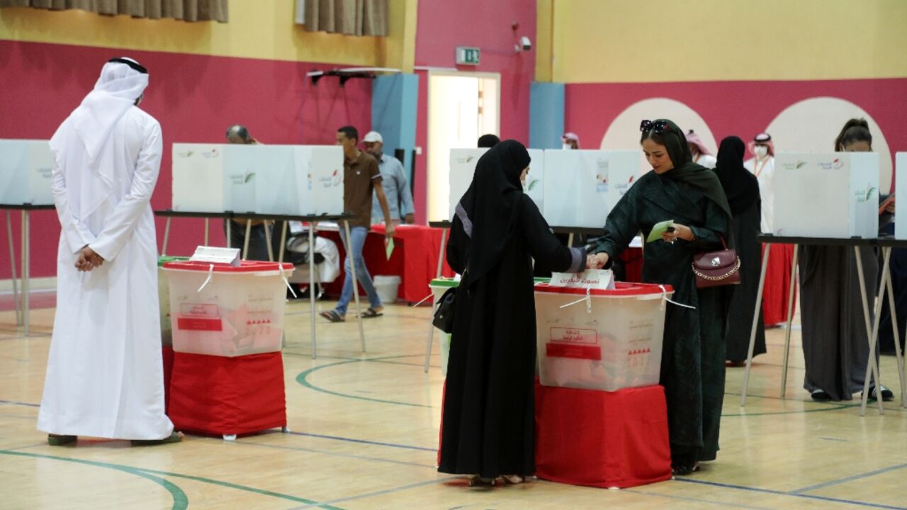A Bahraini woman casts her ballot at a polling station in the city of Jidhafs, about 3km west of the capital Manama, during parliamentary elections on Saturday