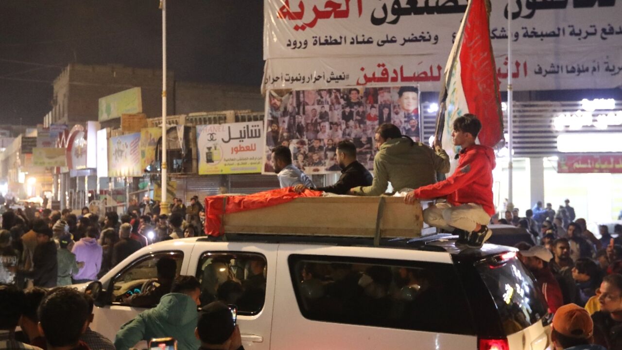 Mourners transport the coffin of one of two protesters killed in clashes on Wednesday with security forces in the southern Iraqi city of Nasiriyah