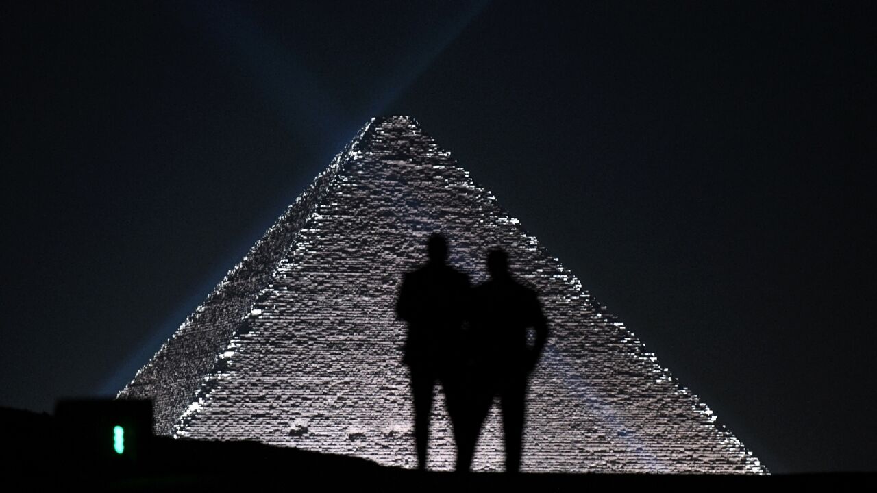 Models are seen against Egypt's Giza Pyramids at show by French fashion house Dior