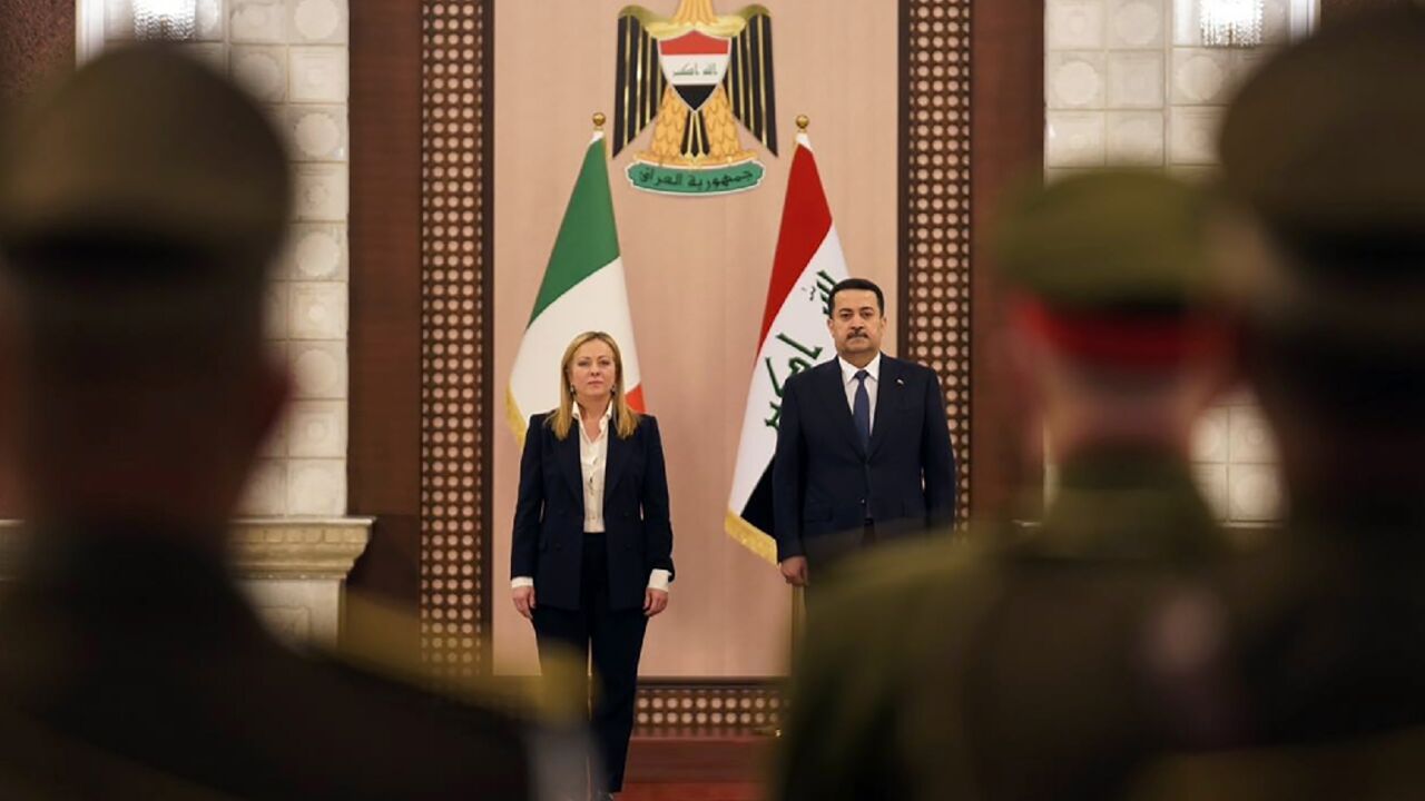 Iraq's Prime Minister Mohammed Shia al-Sudani reviews an honour guard with his Italian counterpart Giorgia Meloni during her visit to Baghdad 