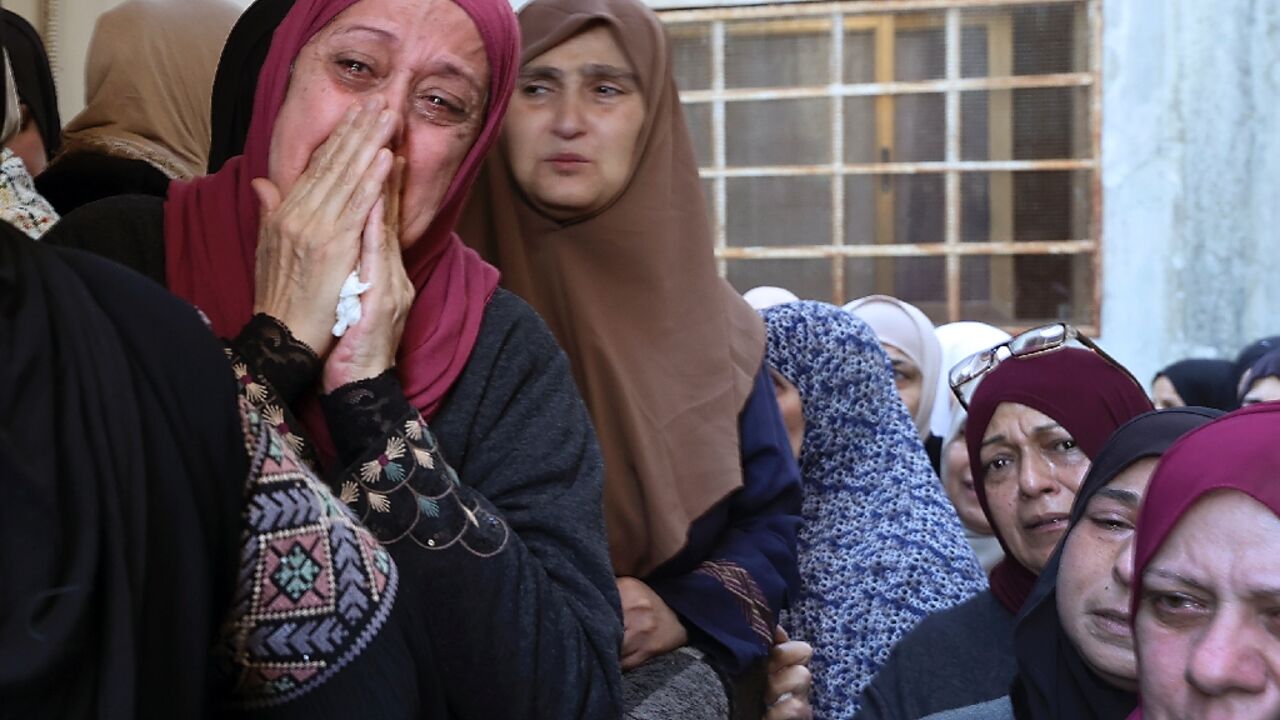 Palestinian mourners cry during the funeral of militant Muhammad Ayman al-Saadi, 26