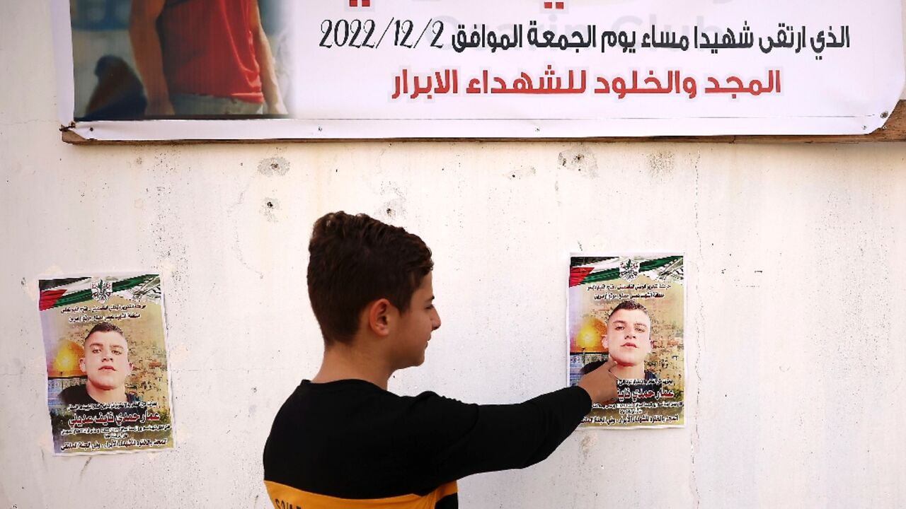 In his West Bank home village, posters mark Ammar Hadi Mufleh's death and his family seeks to claim his body