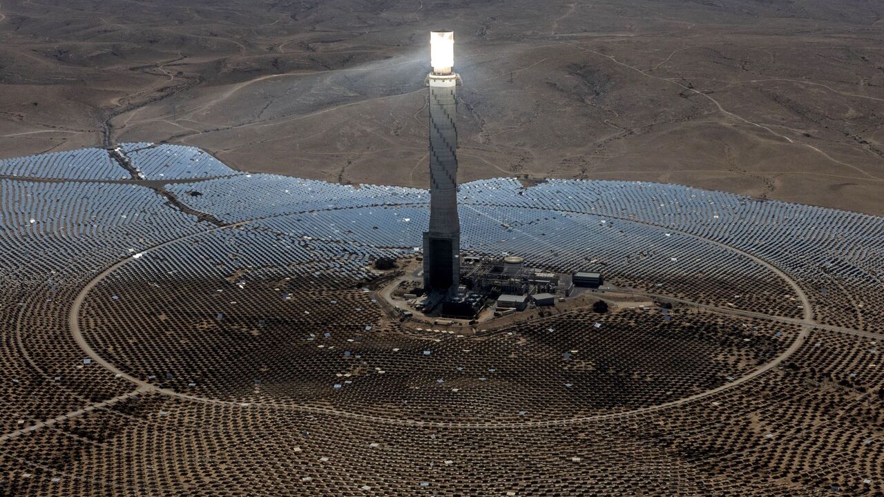 A view shows the solar tower of Israel's Ashalim power station surrounded by panels, in the Negev desert near the kibbutz of Ashalim on Aug. 20, 2022. 