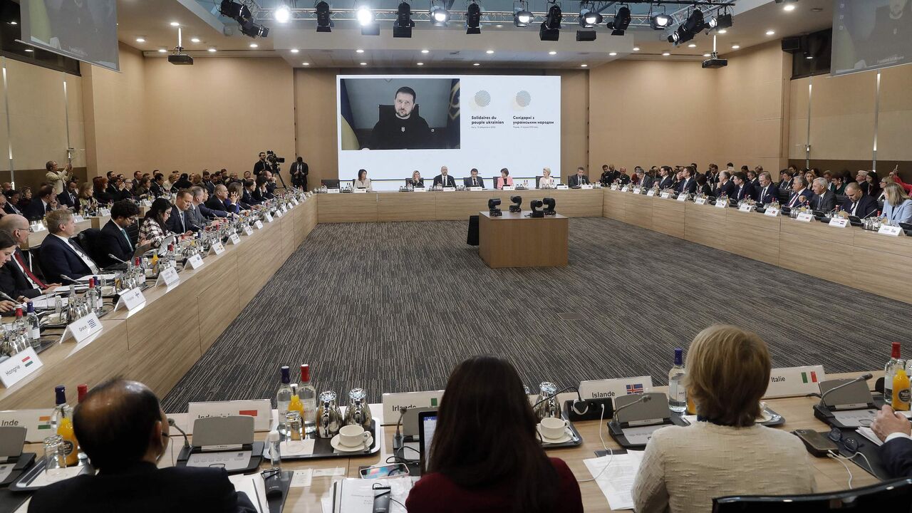 Ukrainian President Volodymyr Zelenskyy is pictured on a screen.