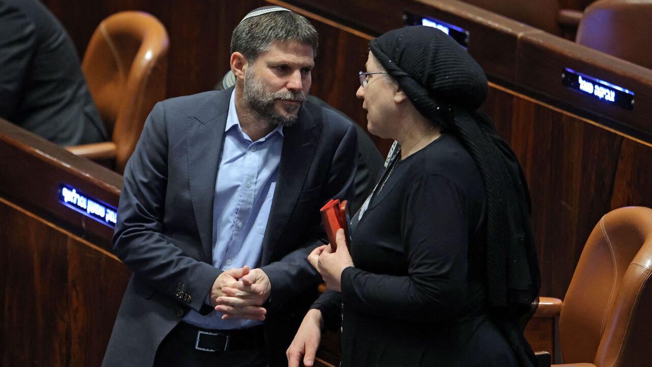 Israeli Knesset (Israeli parliament) member Bezalel Smotrich (L), leader of the Religious Zionist Party, speaks with his colleague and party member Orit Strook (R).