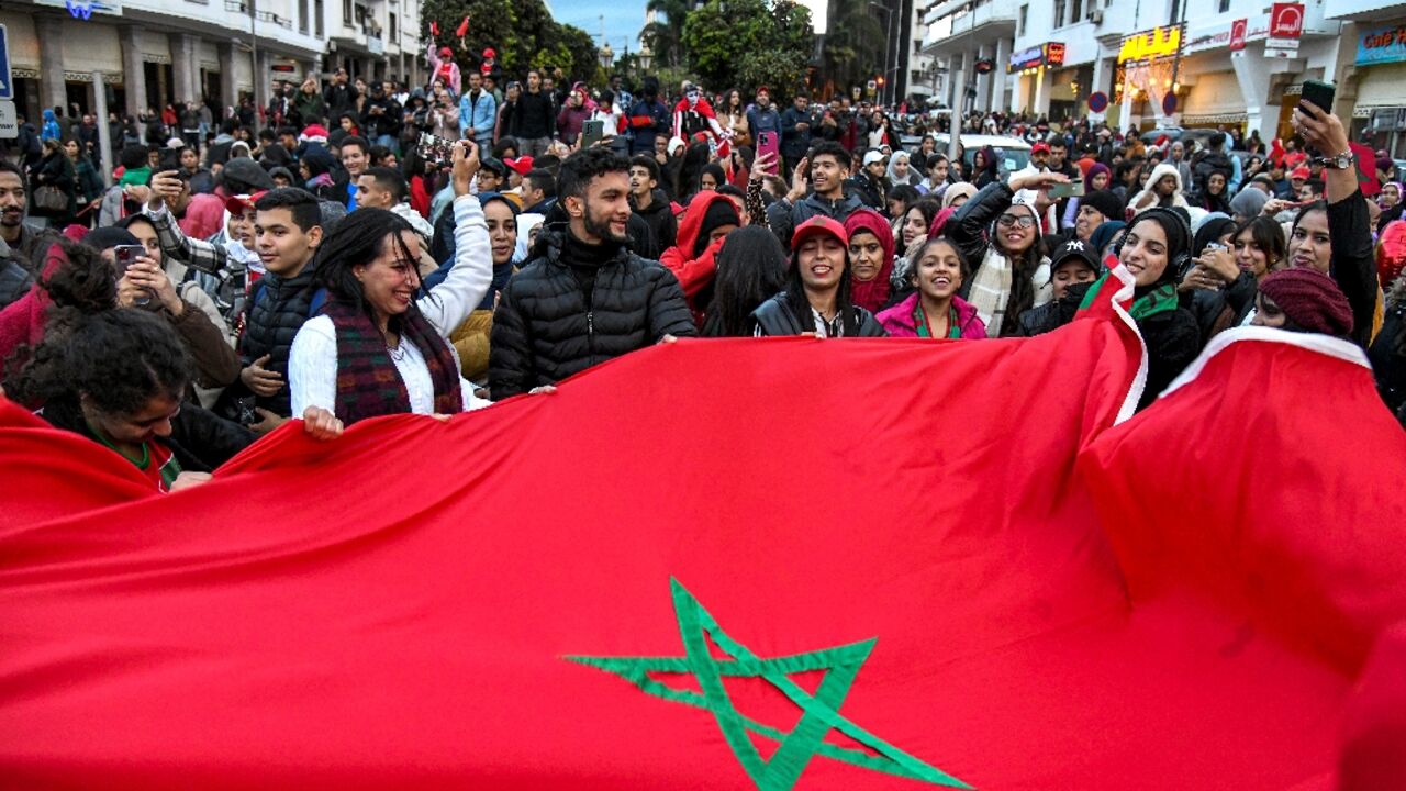 Moroccan fans celebrate in the capital Rabat after their team became the only one from an Arab nation to reach the World Cup second round