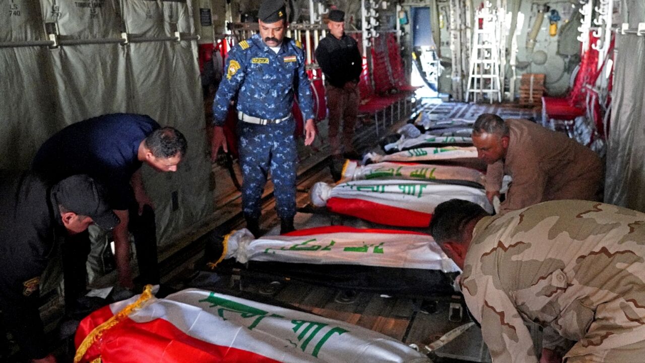 The bodies of Iraqi police officers, killed in an attack on Sunday by Islamic State group jihadists, are flown out from Kirkuk airport in northern Iraq