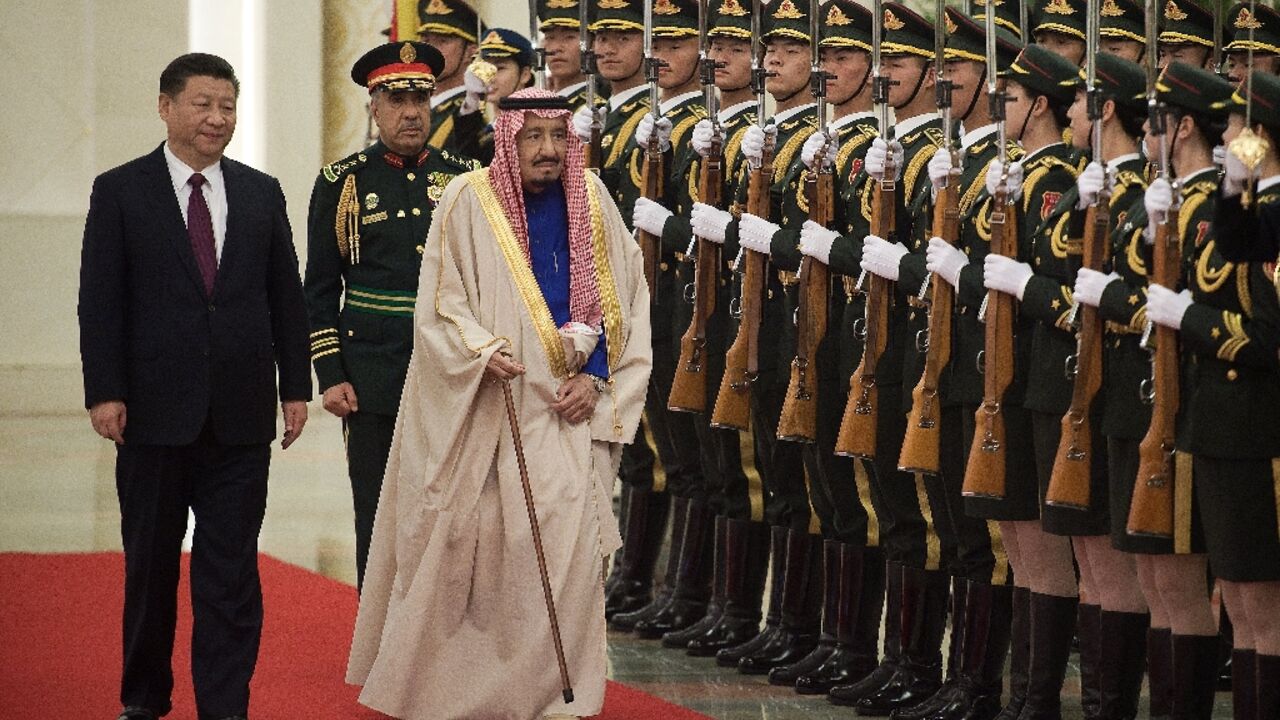In this file photo Saudi King Salman Bin Abdul-Aaziz Al-Saud reviews an honour guard with Chinese President Xi Jinping  during a welcome ceremony at the Great Hall of the People in Beijing on March 16, 2017 